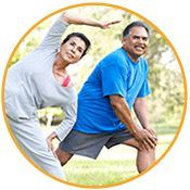 middle aged couple stretching before exercising in a park