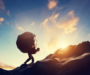 Carrying a boulder up a hill.