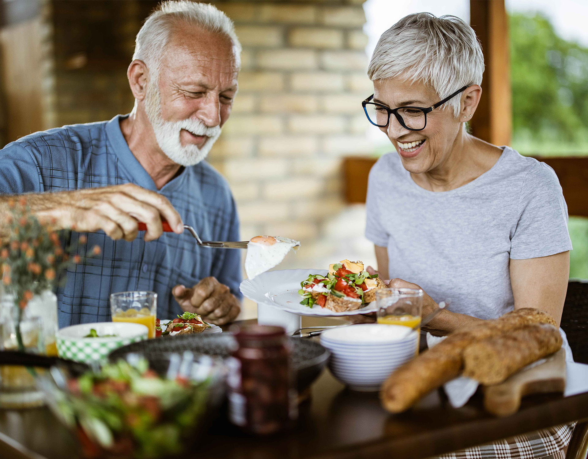  A couple eating a well balanced meal with carbs, protein, and vegetables.