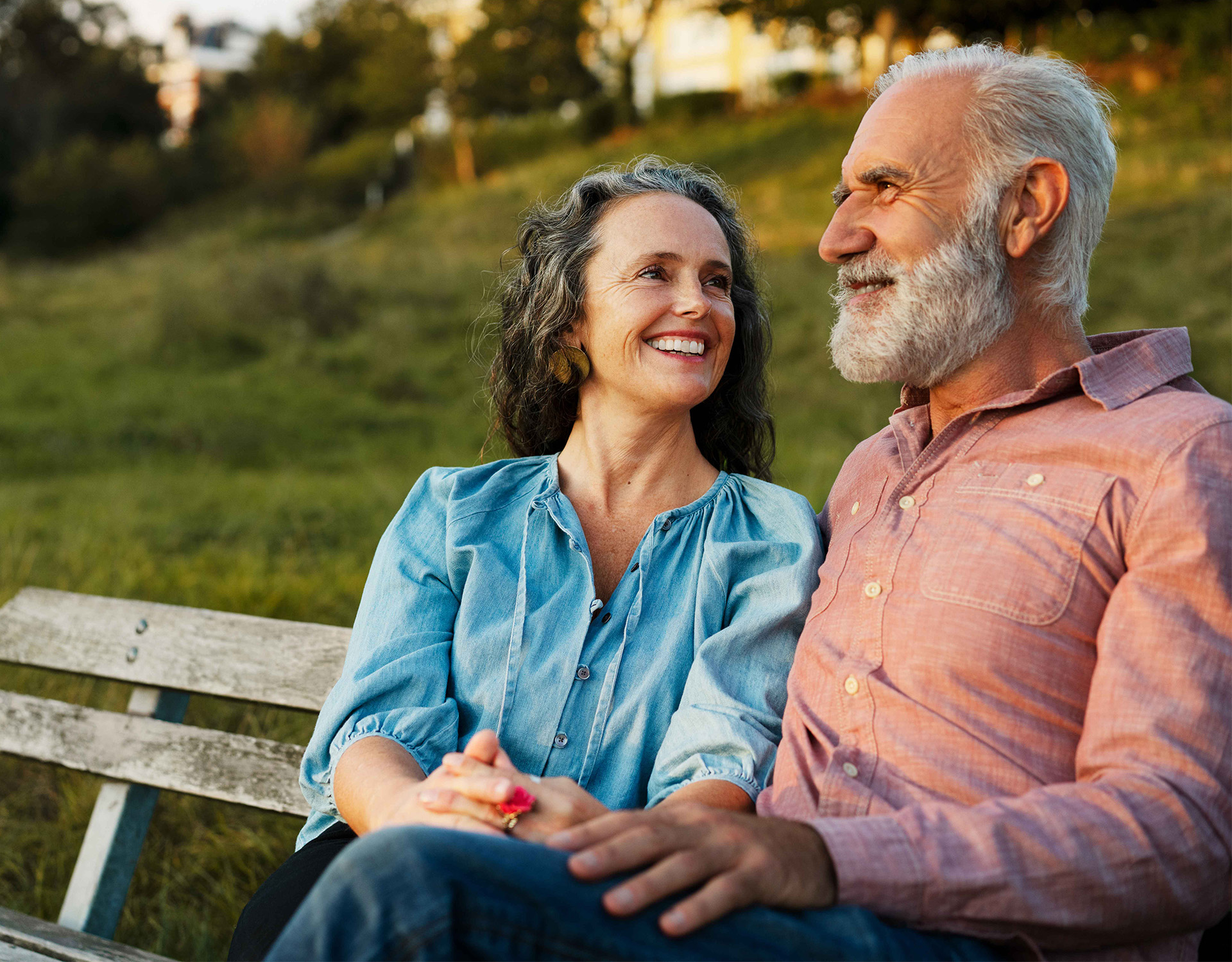Couple sitting on a park bench.