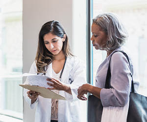 Clinician and patient in a hallway.