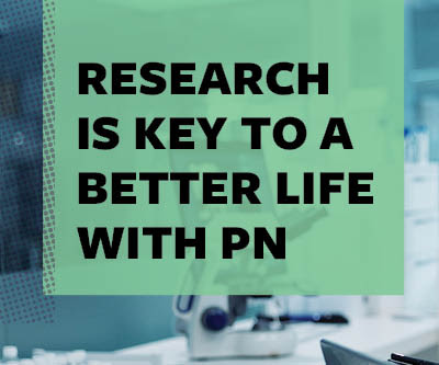 Image of lab equipment. Text overlaying the image reads: "Research is key to a better life with PN."